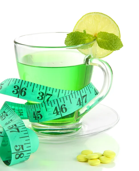 Transparent cup of green tea and measuring tape isolated on white — Stock Photo, Image