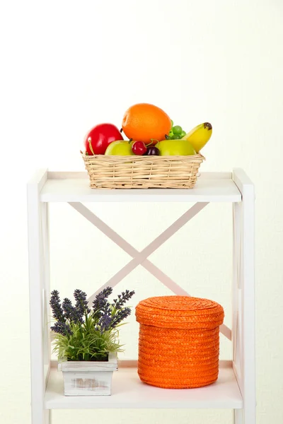 Composition of various home furnishing on white shelf on grey wall background — Stock Photo, Image