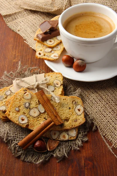 Cup of tasty coffee with Italian biscuit, on wooden background — Stock Photo, Image