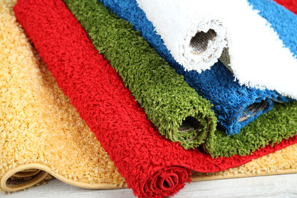 Many carpets of different colors close-up