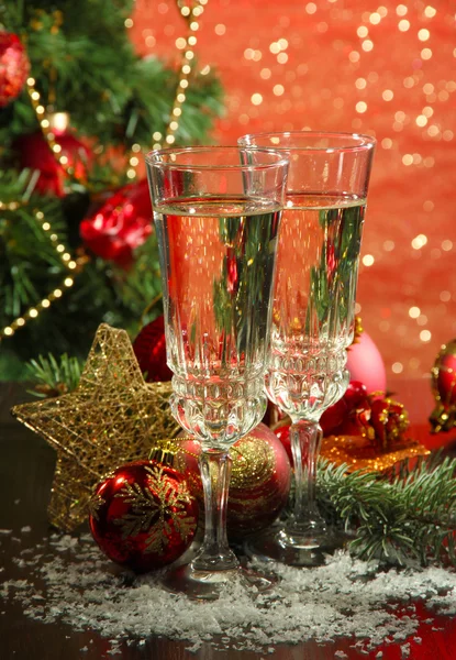 Composition with Christmas decorations and two champagne glasses, on bright background — Stock Photo, Image