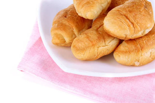 Tasty croissants on plate close-up — Stock Photo, Image