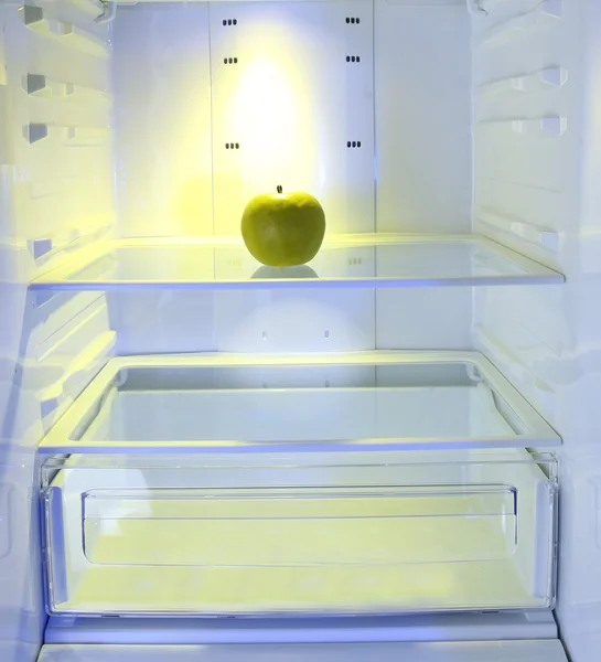 One apple in open empty refrigerator. Weight loss diet concept. — Stock Photo, Image