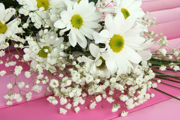 Beautiful flowers on wooden background — Stock Photo, Image