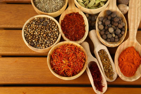 Many different spices and fragrant herbs on wooden table close-up — Stock Photo, Image