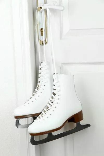 Figure skates hanging on a door knob — Stock Photo, Image