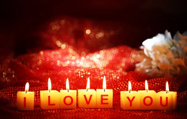 Candles with printed sign I LOVE YOU,on bright background — Stock Photo, Image