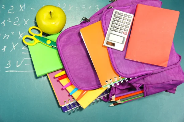 Purple backpack with school supplies — Stock Photo, Image