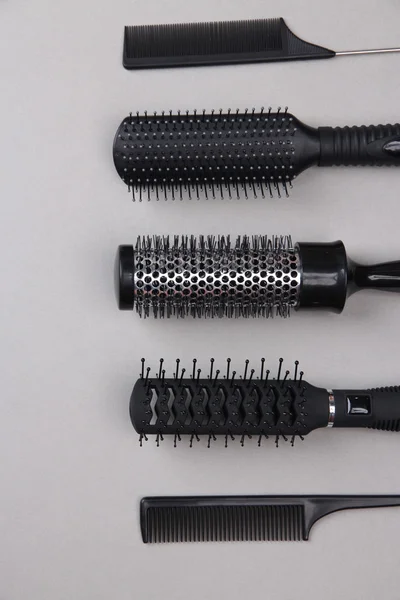 Black combs on gray background — Stock Photo, Image