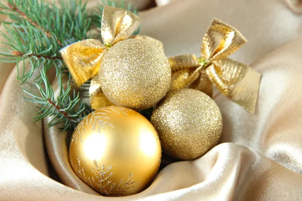Beautiful Christmas decor on golden satin cloth — Stock Photo, Image