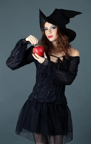 Halloween witch with broom on gray background — Stock Photo, Image