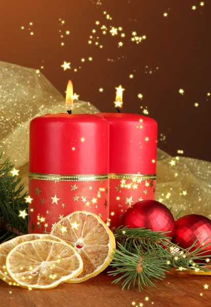 Two candles and Christmas decorations, on wooden background — Stock Photo, Image