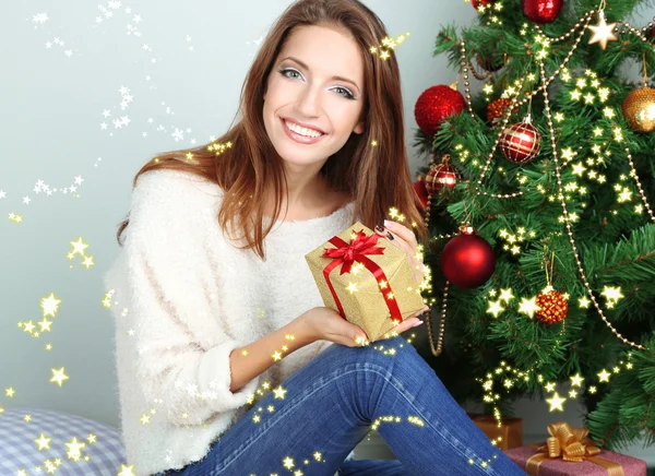 Menina bonita perto da árvore de Natal com presente — Fotografia de Stock