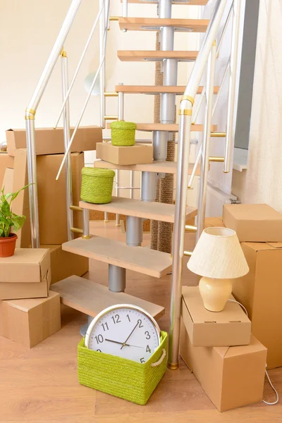 Stack of cartons near stairs: moving house concept — Stock Photo, Image