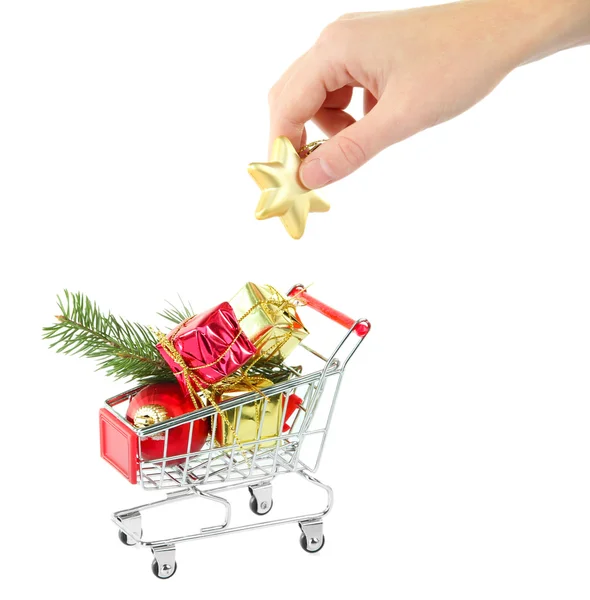 Hand and Christmas gifts in shopping trolley — Stock Photo, Image
