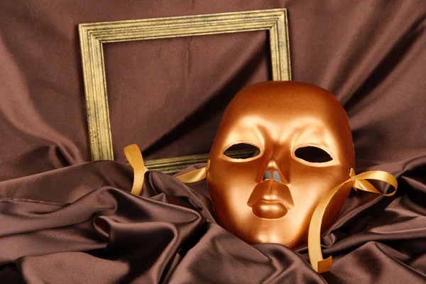 Mask on brown fabric background — Stock Photo, Image