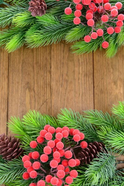 Christmas tree branches on wooden background — Stock Photo, Image