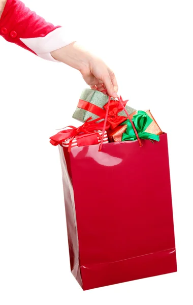 Hand holds package with New Year gifts isolated on white — Stock Photo, Image