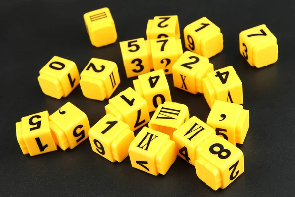 Educational cubes with different numbers on black board — Stock Photo, Image