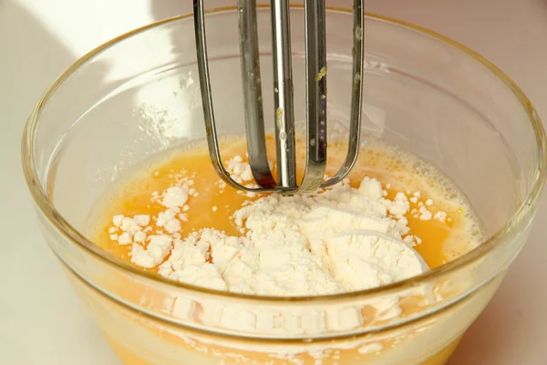 Cooking, whipping eggs with electric whisk in bowl, close up — Stock Photo, Image