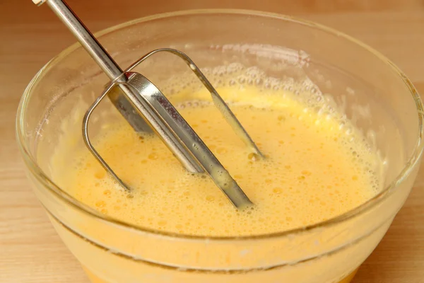Cozinhar, bater ovos com batedor elétrico na tigela, close-up — Fotografia de Stock