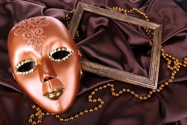 Mask on brown fabric background — Stock Photo, Image