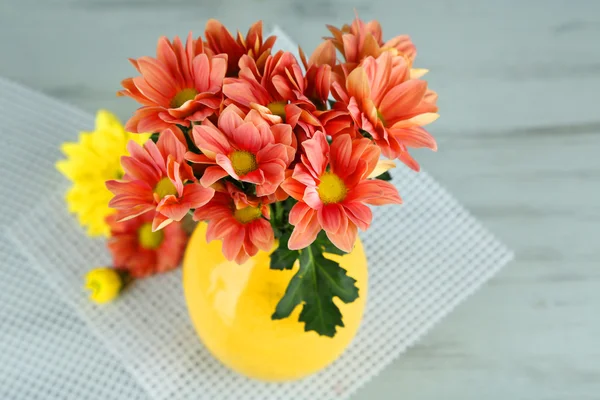Beautiful flowers in vase, on wooden background — Stock Photo, Image