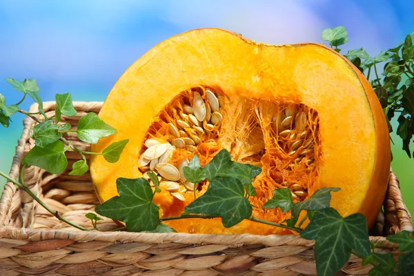 Cut pumpkin on wooden table on natural background — Stock Photo, Image