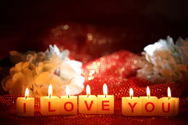 Candles with printed sign I LOVE YOU,on bright background — Stock Photo, Image