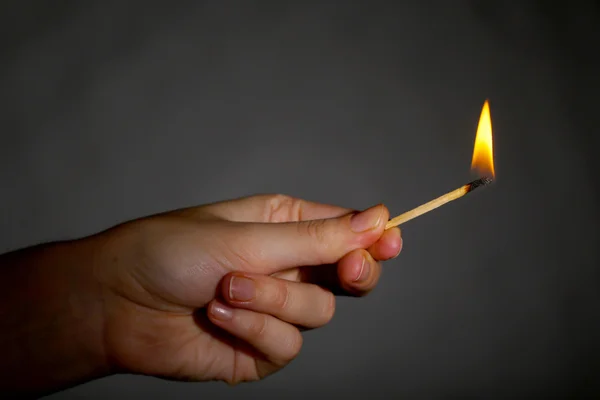 Burning match in hand — Stock Photo, Image