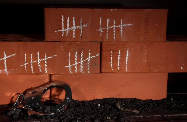 Counting days by drawing sticks on bricks on dark background — Stock Photo, Image