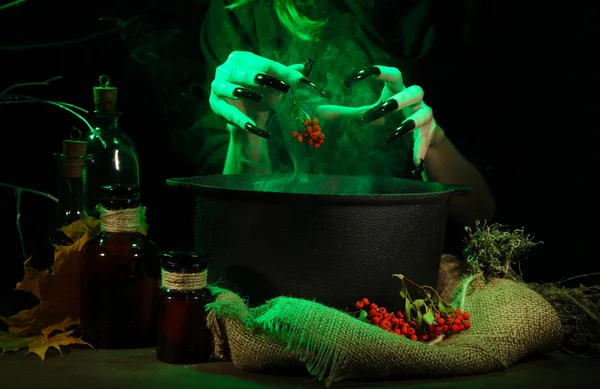 Witch in scary Halloween laboratory on dark color background — Stock Photo, Image