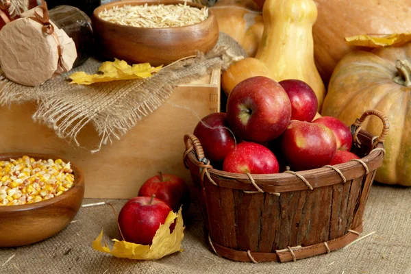 Fruits and vegetables with jar of jam and bowls of grains on sackcloth close up — Stock Photo, Image