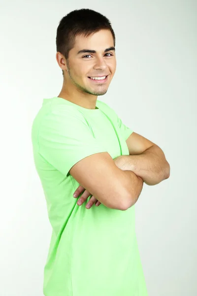 Portrait of young man on grey background — Stock Photo, Image