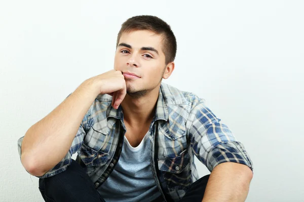 Guy sitting on floor in room — Stock Photo, Image