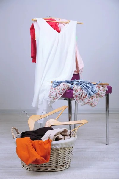 Högen av kläder på färg stol, på grå bakgrund — Stockfoto