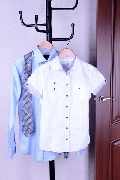 Skjortor hänger på galge nära dörren — Stockfoto