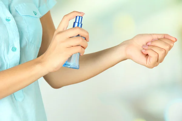 Woman testing perfume on natural background Stock Picture