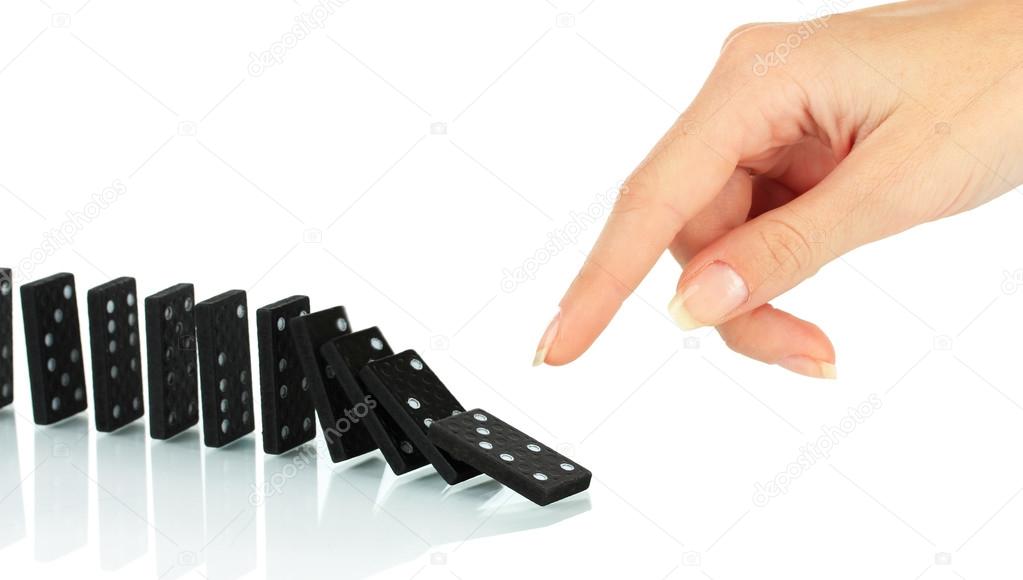 Hand pushing dominoes isolated on white