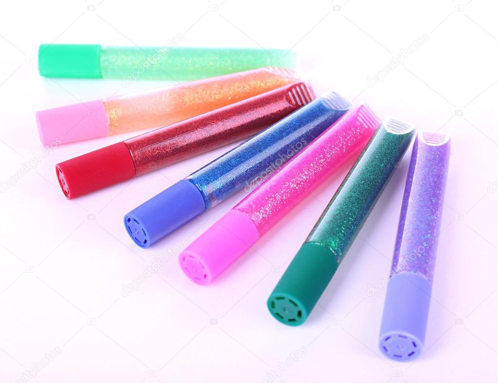 Colorful glitter glue isolated on white
