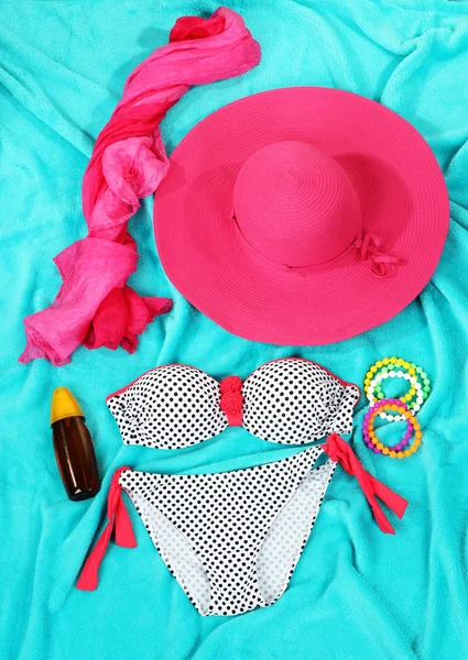 Swimsuit and beach items on bright blue background — Stock Photo, Image
