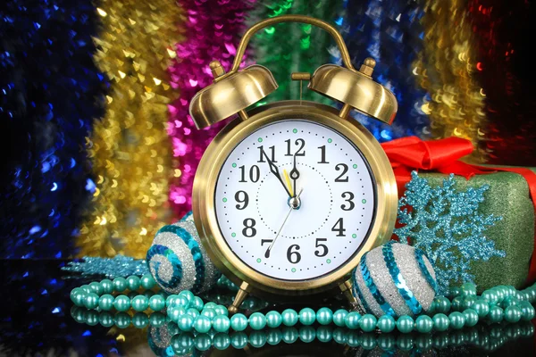 Composition of clock and christmas decorations on bright background — Stock Photo, Image