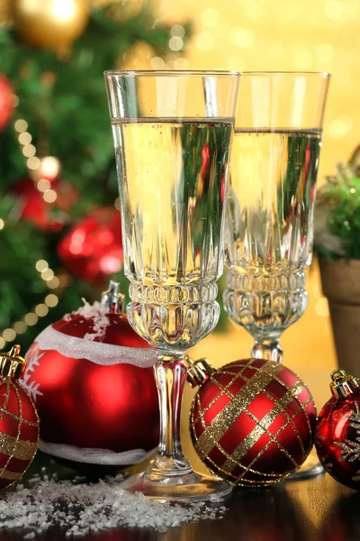 Composition with Christmas decorations and two champagne glasses, on bright background — Stock Photo, Image