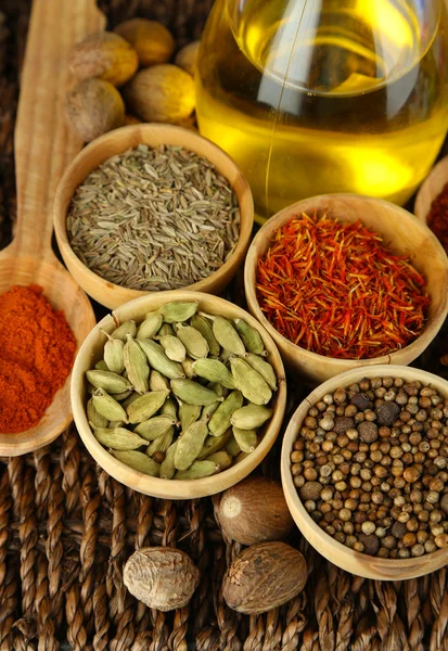 Many different spices and fragrant herbs on braided table close-up — Stock Photo, Image