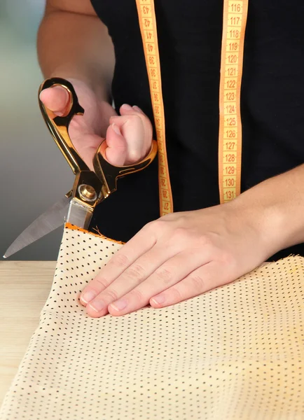 Cutting fabric with tailors scissors — Stock Photo, Image