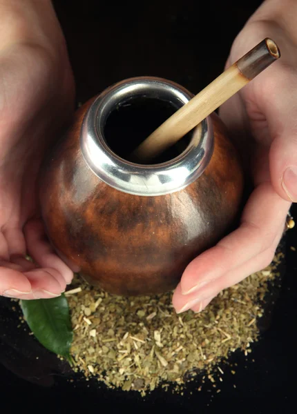 Woman hands holding calabash and bombilla with yerba mate isolated on black — Stock Photo, Image