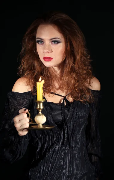 Halloween witch with candle isolated on black — Stock Photo, Image