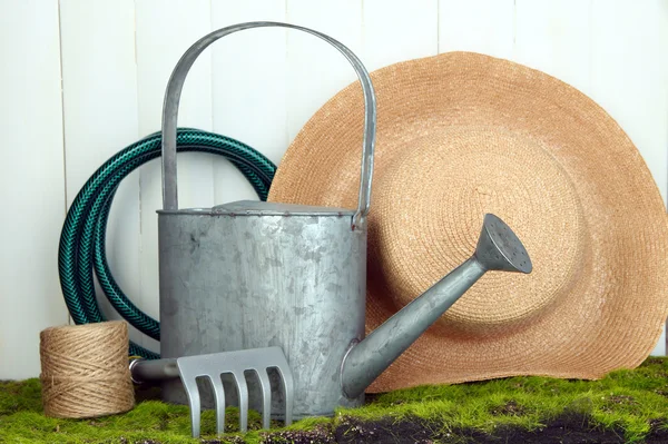 Gardening tools on grass on wooden background — Stock Photo, Image