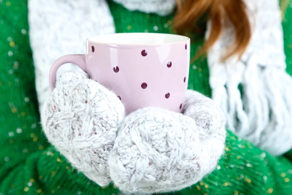 Womens hands in mittens with cup isolated on white — Stock Photo, Image