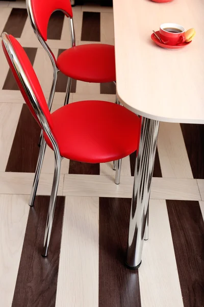 Modern red chairs near table in kitchen — Stock Photo, Image